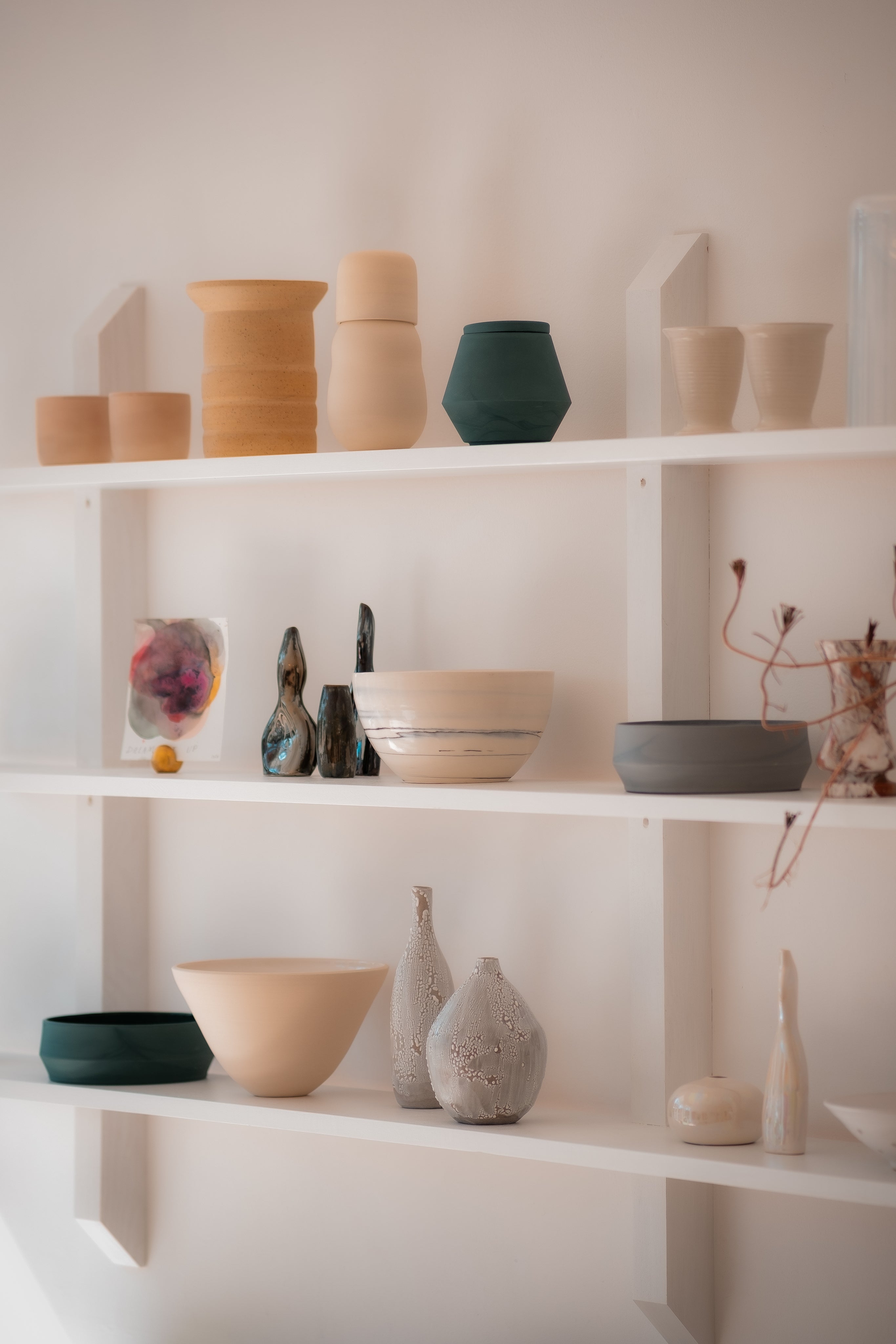 wiggetty white shelves filled with pottery and bowls